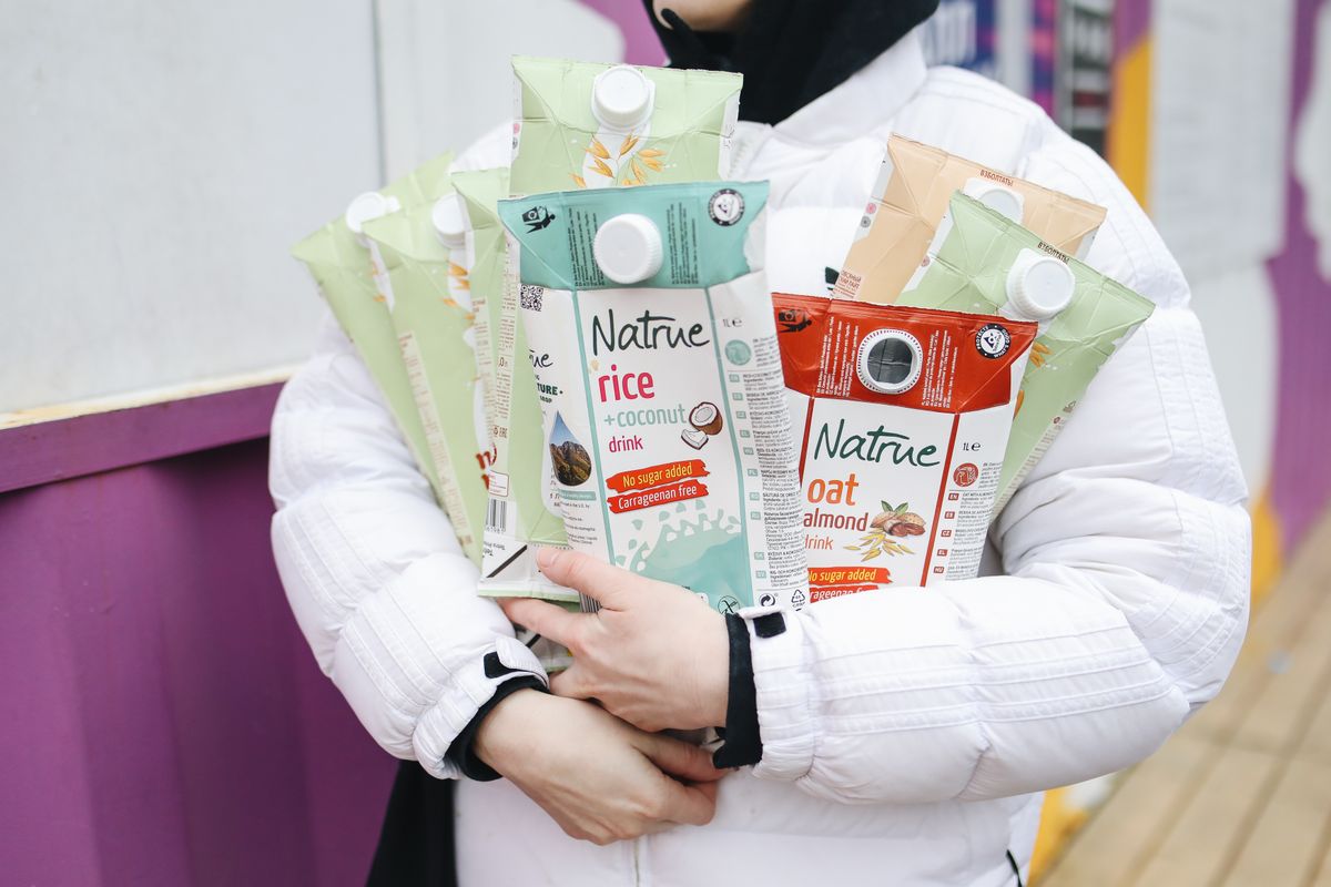 Drink cartons held in a hand