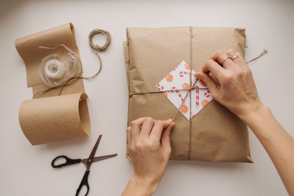 Wrapping a gift with paper and string
