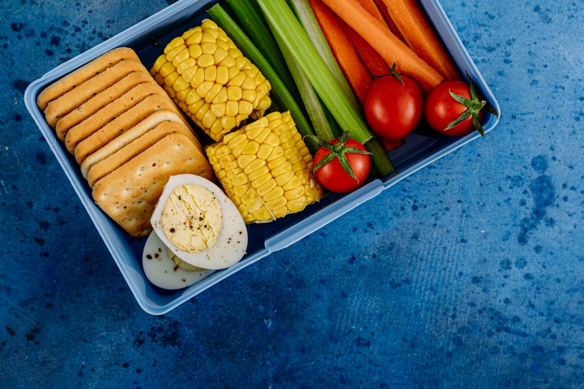 Lunch box with vegetables and snacks