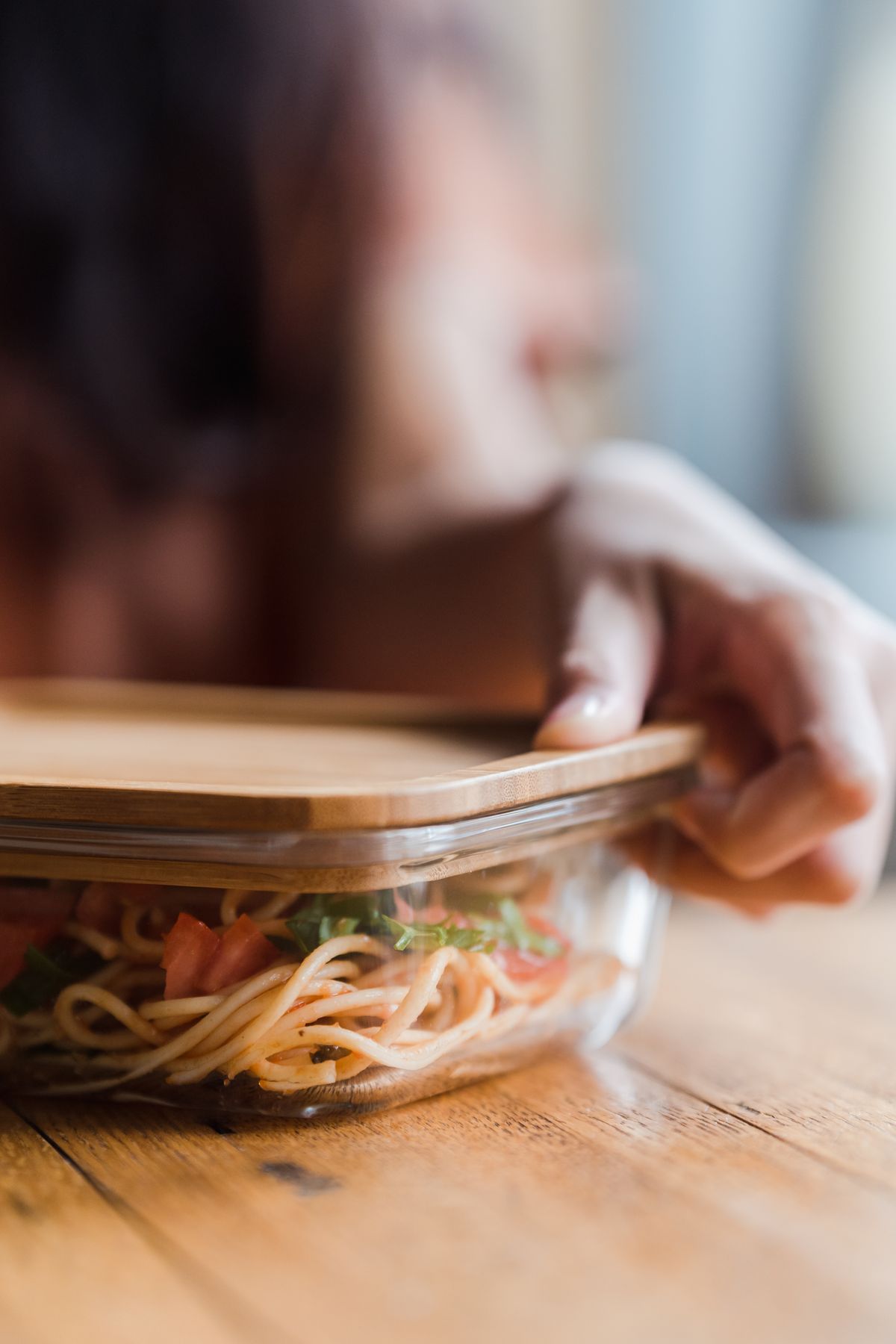 Placing a lid on a food container