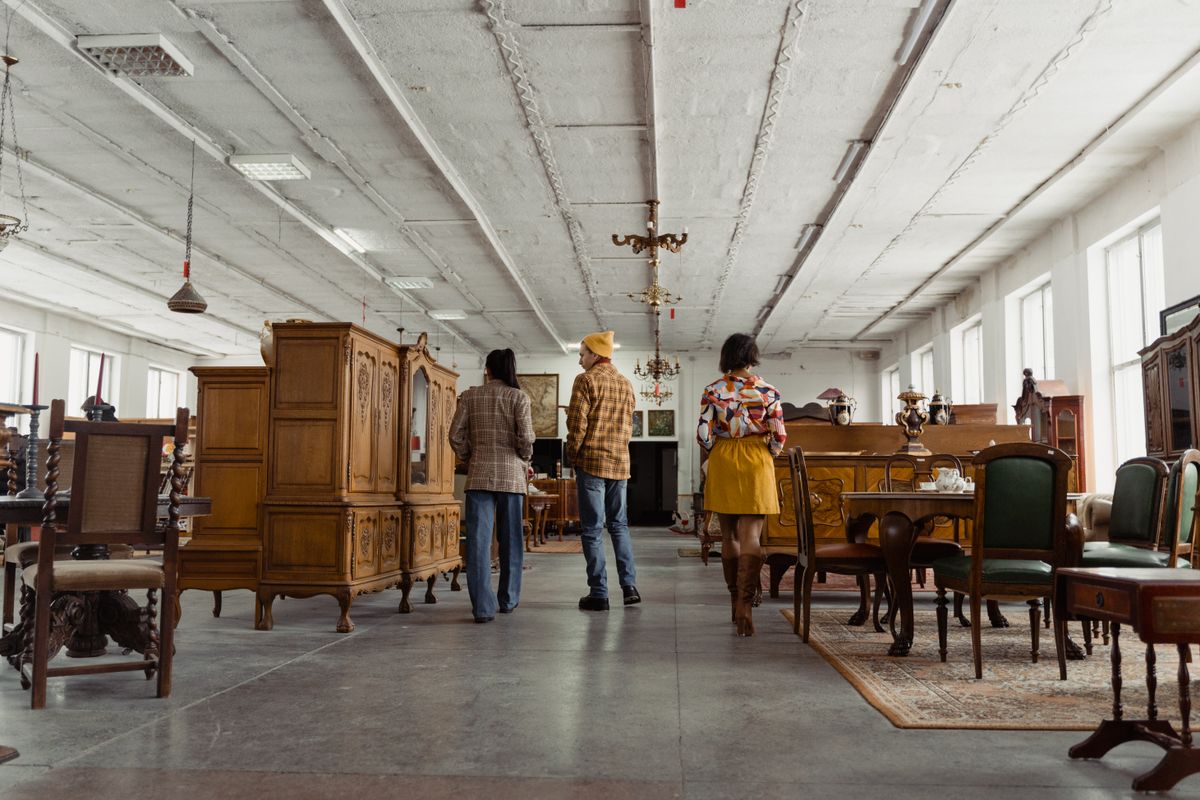 People browsing secondhand wooden furniture